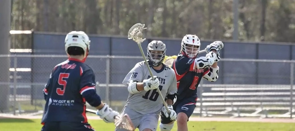 Lacrosse team playing wearing Wooter Apparel's custom lacrosse uniforms.