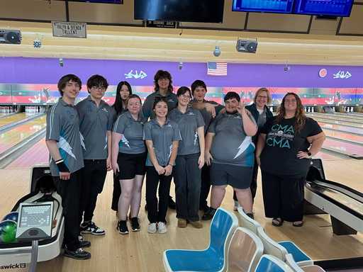 Group wearing black custom sublimated polo shirts at bowling alley