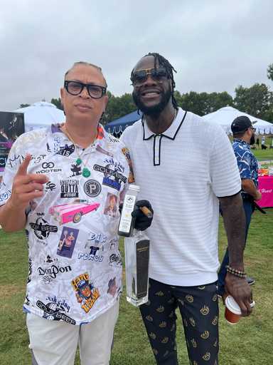 Two men wearing custom sublimated polo shirts at outdoor event