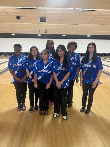 Team wearing matching sublimated polo shirts indoors