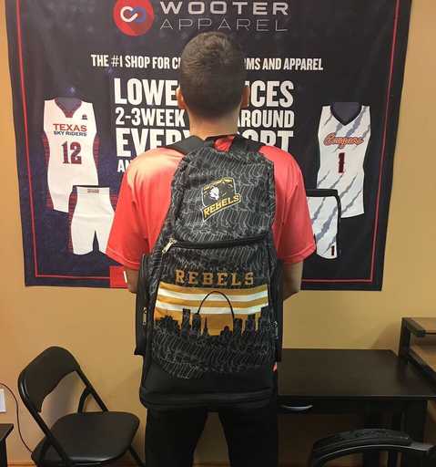 Player wearing black custom basketball backpack with team design