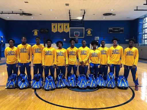 Basketball team with matching custom basketball bags in gym