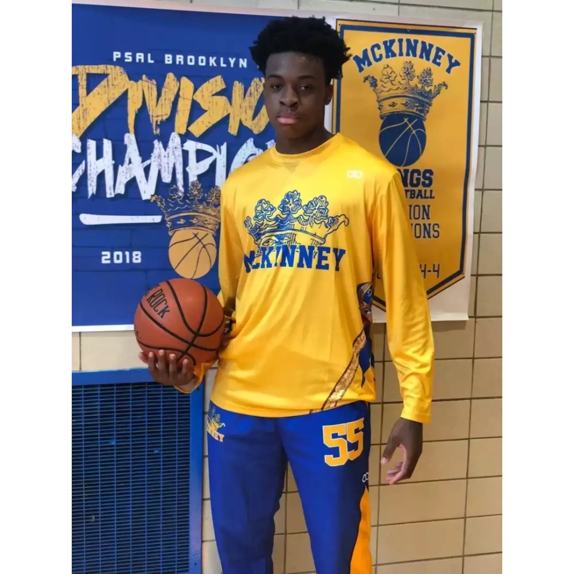 Player wearing yellow and blue custom basketball shooting shirt
