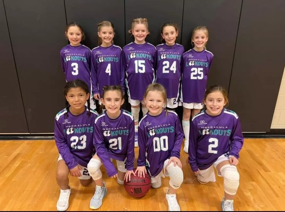 Youth basketball team wearing purple custom basketball shooting shirts