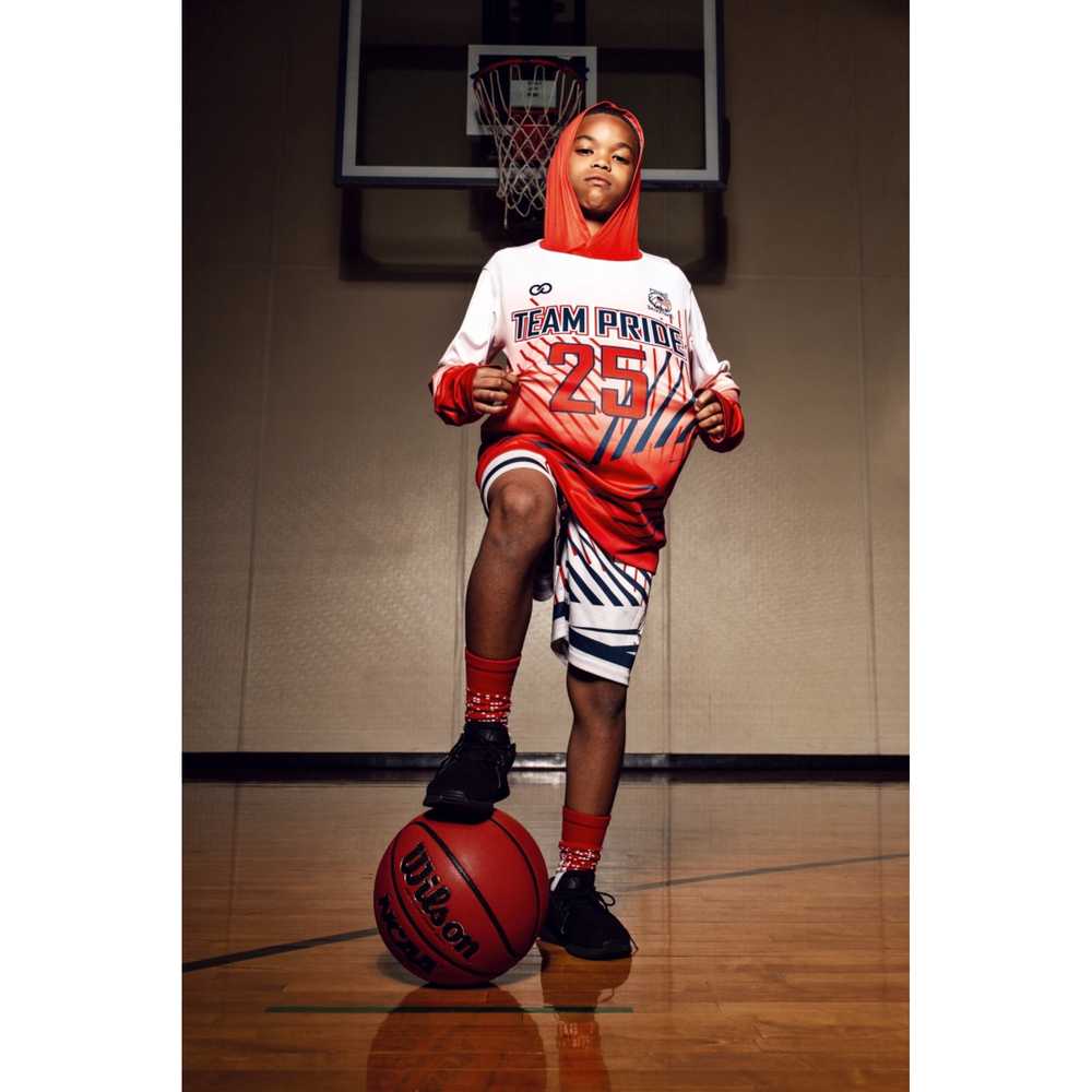 Player wearing custom hooded basketball shooting shirt with ball