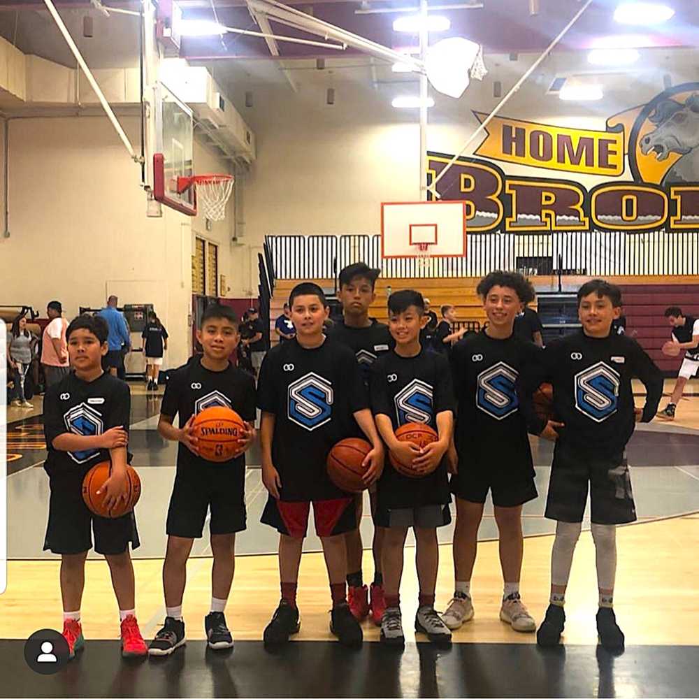 Youth team wearing black custom basketball shooting shirts