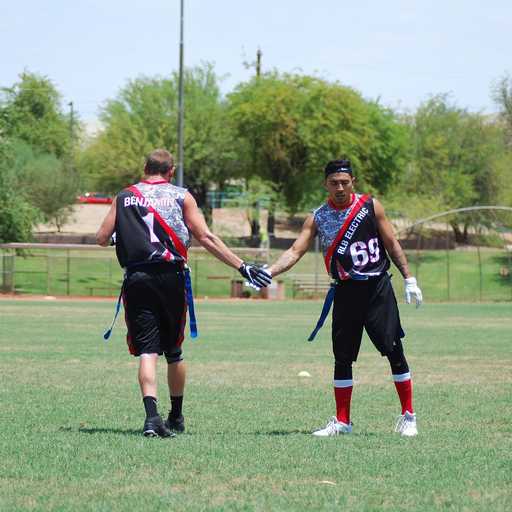 Players wearing black custom flag football shorts during game