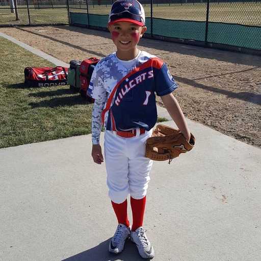 Player wearing custom 2 button baseball jersey on baseball field