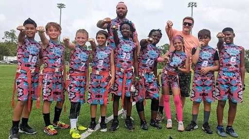 Youth team wearing matching custom flag football shorts