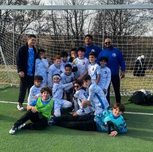 Soccer team wearing light blue custom reversible soccer jerseys outdoors