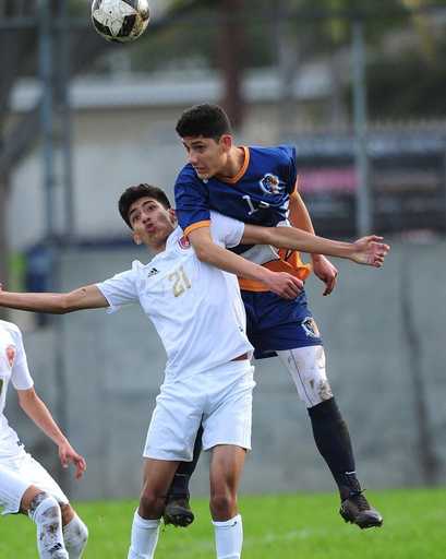 Soccer players competing in custom reversible v-neck soccer jerseys