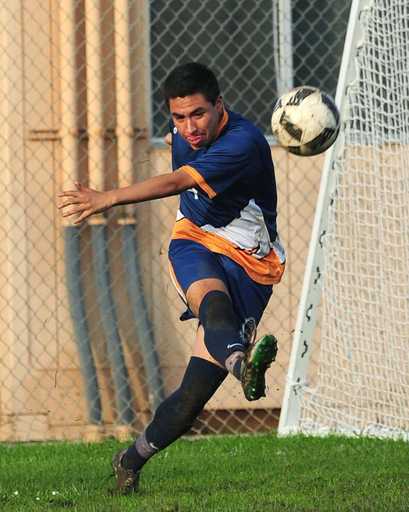 Soccer player wearing blue custom reversible v-neck soccer jersey