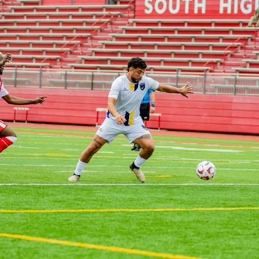 Player wearing white custom reversible crew neck soccer jersey during game