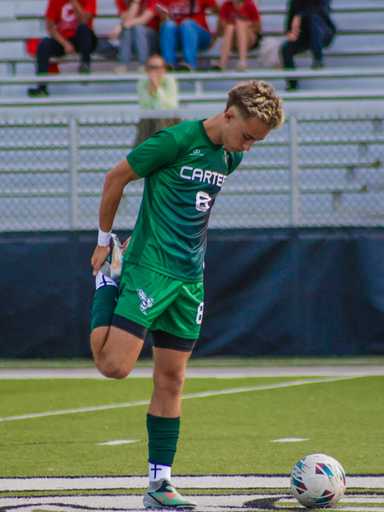 Player wearing green custom reversible soccer jersey v-neck design