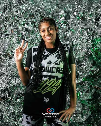 Player wearing black custom athletic jersey with green design