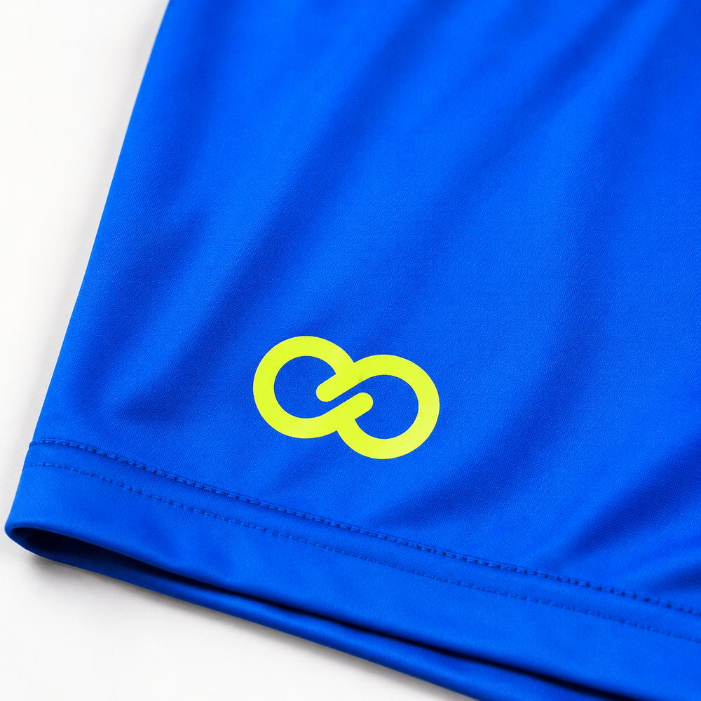 Close-up of custom soccer shorts with yellow Wooter logo on royal blue performance fabric