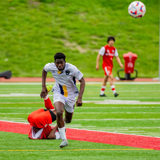 Soccer player in custom soccer shorts making a slide tackle during a match