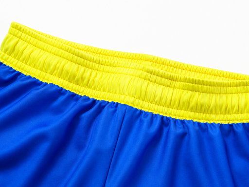 Custom soccer shorts elastic yellow waistband close-up with royal blue fabric detail