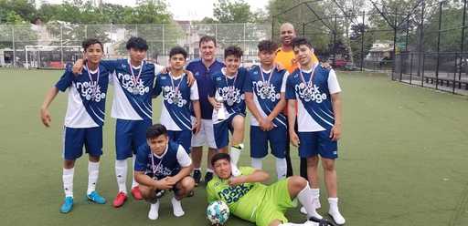 Youth soccer team wearing custom soccer shorts and matching uniforms on the field