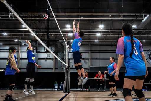 Volleyball players wearing reversible volleyball uniforms during practice