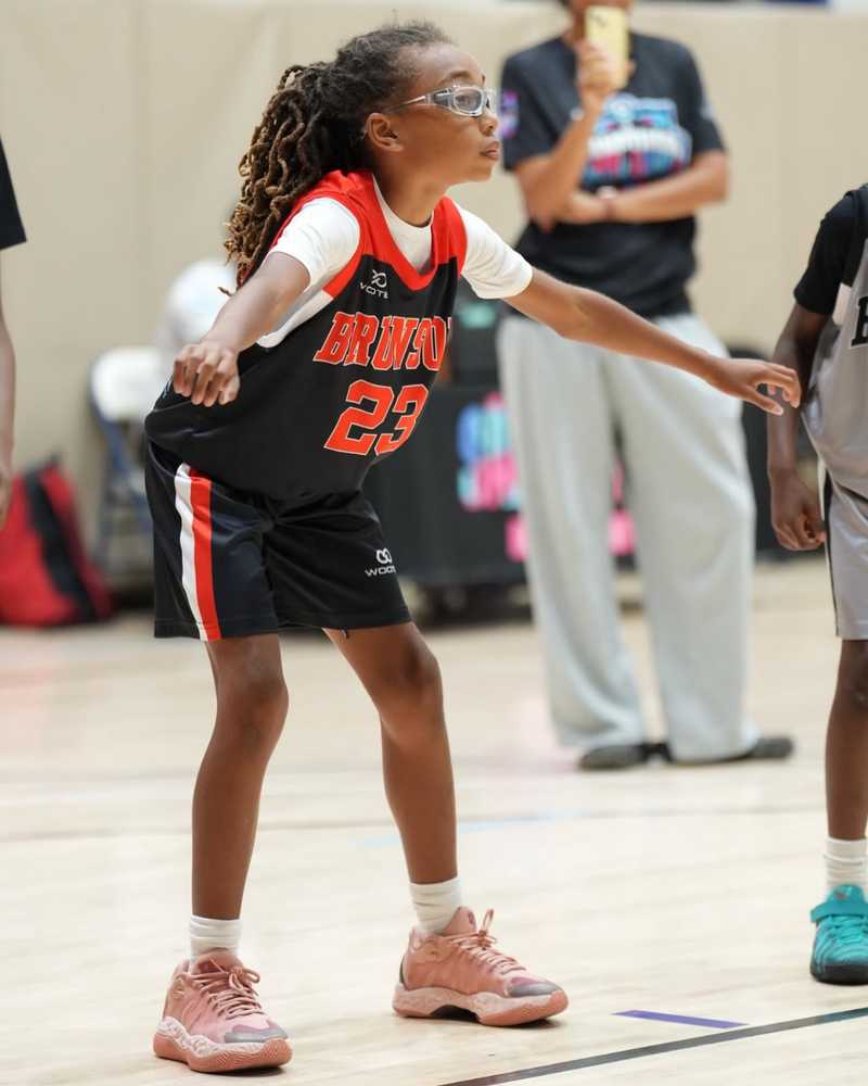 Basketball player wearing custom team shorts during indoor practice