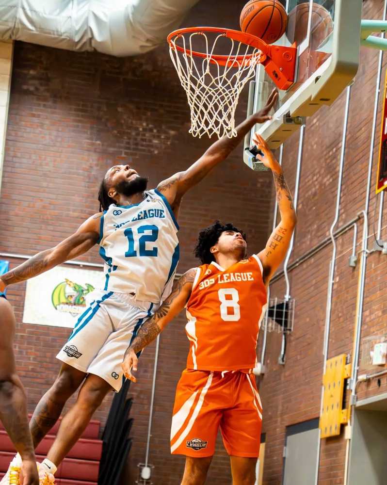 Basketball players in custom team shorts during an indoor game