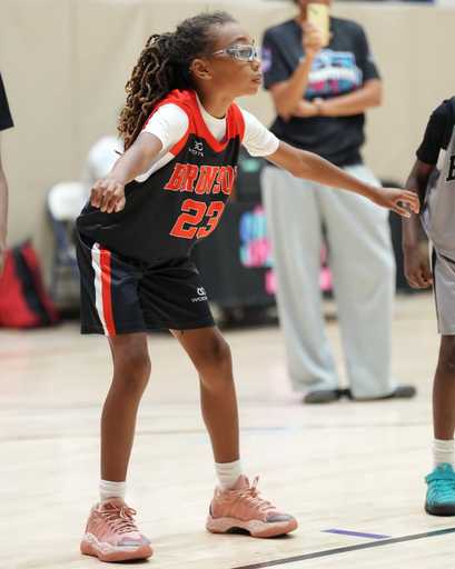 Basketball player wearing custom team shorts during indoor practice
