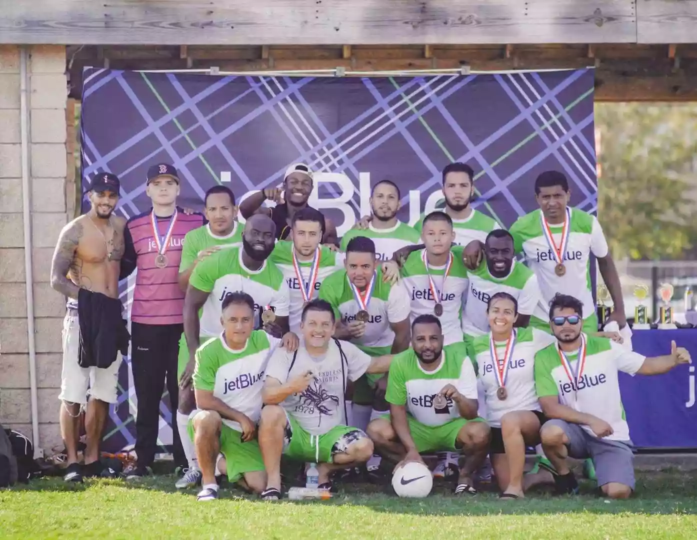 Team wearing green and white custom crew neck soccer jerseys after match
