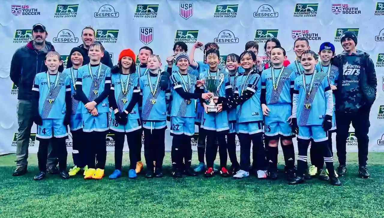 Youth soccer team wearing blue custom crew neck soccer jerseys